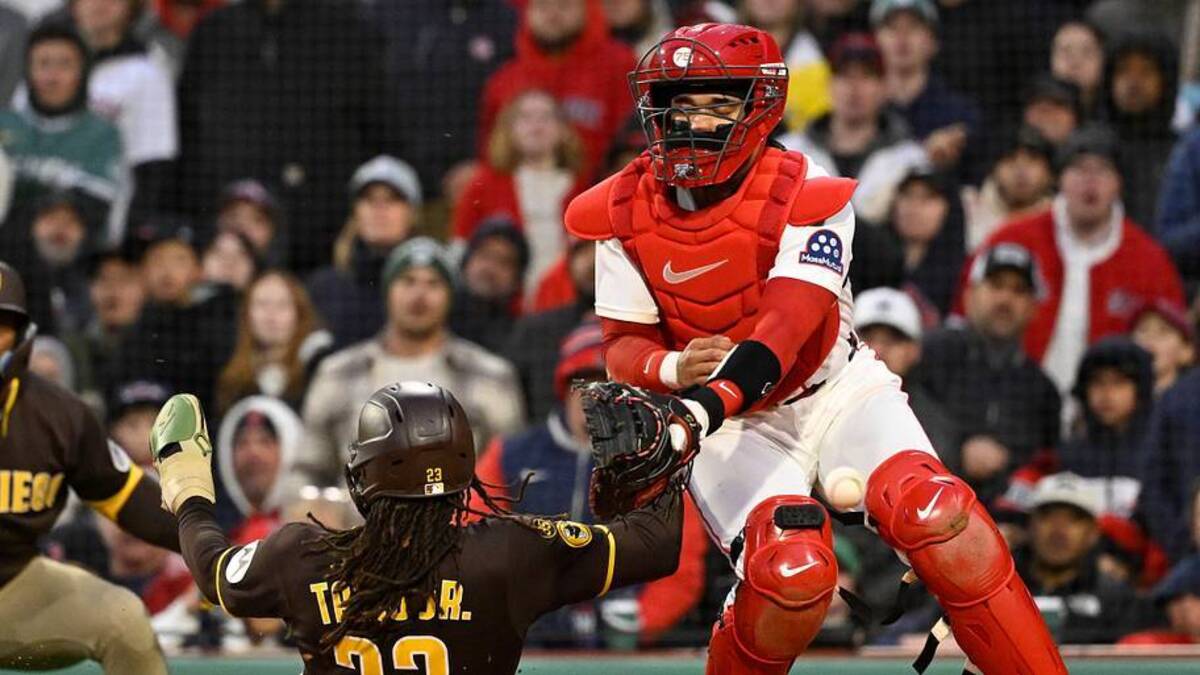  San Diego Padres right fielder Fernando Tatis Jr. (23) scores a run against Boston Red Sox catcher Carlos Narvaez (75) during the ninth inning at Fenway Park. | Eric Canha-Imagn Images 