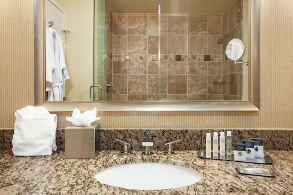 Elegant granite countertops add a touch of luxury to the modern bathroom at DoubleTree by  Hilton  Love Field. Photo credit: DoubleTree by  Hilton 