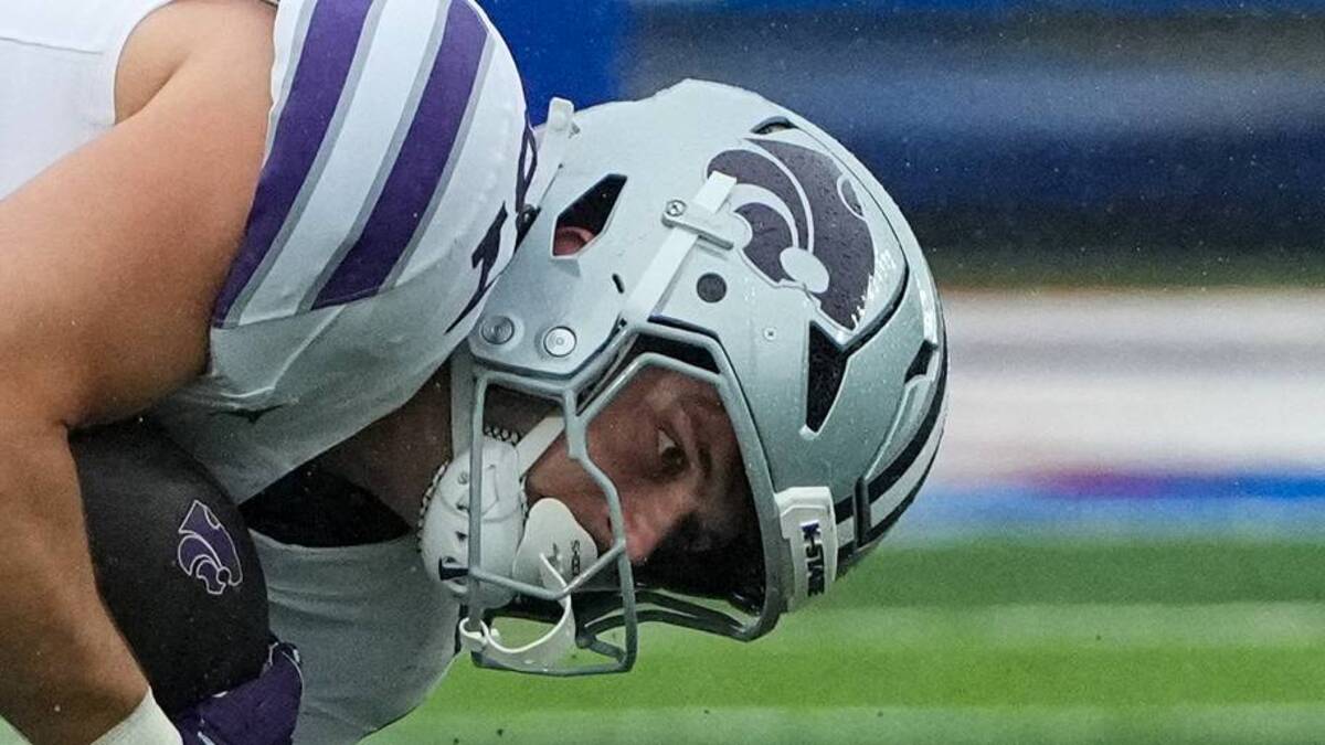  Oct 25, 2025; Lawrence, Kansas, USA; Kansas State Wildcats tight end Brayden Loftin (87) runs the ball as Kansas Jayhawks linebacker Trey Lathan (4) makes the tackle during the first half of the game at David Booth Kansas Memorial Stadium. Mandatory Credit: Denny Medley-Imagn Images | IMAGN IMAGES via Reuters Connect 