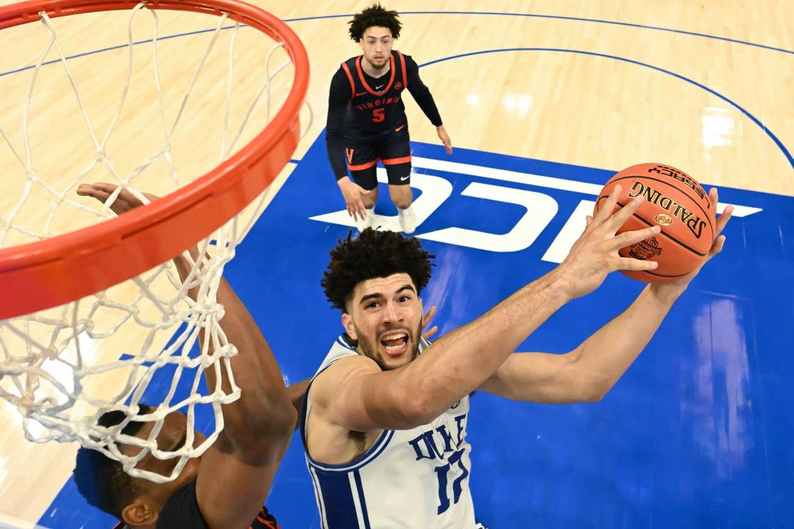  Duke Blue Devils forward Cameron Boozer (12) goes to the basket against Virginia Cavaliers center Ugonna Onyenso (33) during the men's ACC Conference Tournament Championship at Spectrum Center in Charlotte. Bob Donnan-Imagn Images