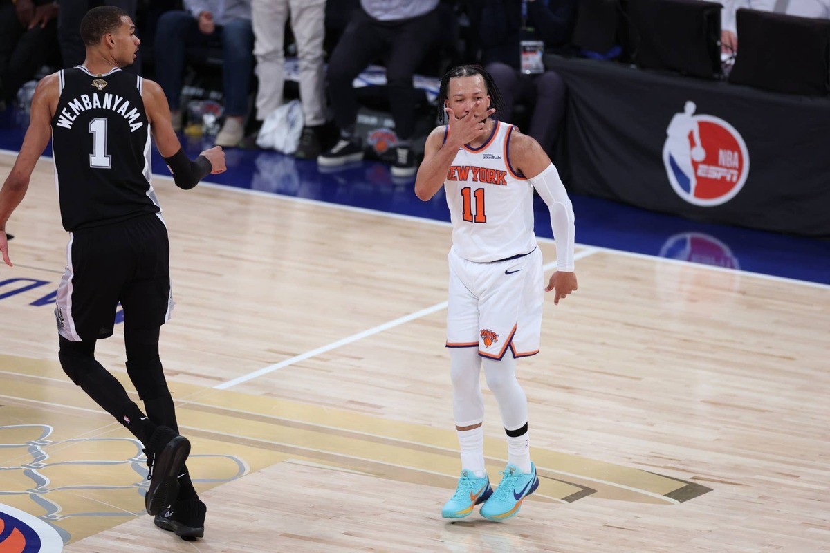  Jun 8, 2026; New York, New York, USA; New York Knicks guard Jalen Brunson (11) reacts as San Antonio Spurs forward Victor Wembanyama (1) looks on in the second quarter during game three of the 2026 NBA Finals at Madison Square Garden. Mandatory Credit: Vincent Carchietta-Imagn Images 