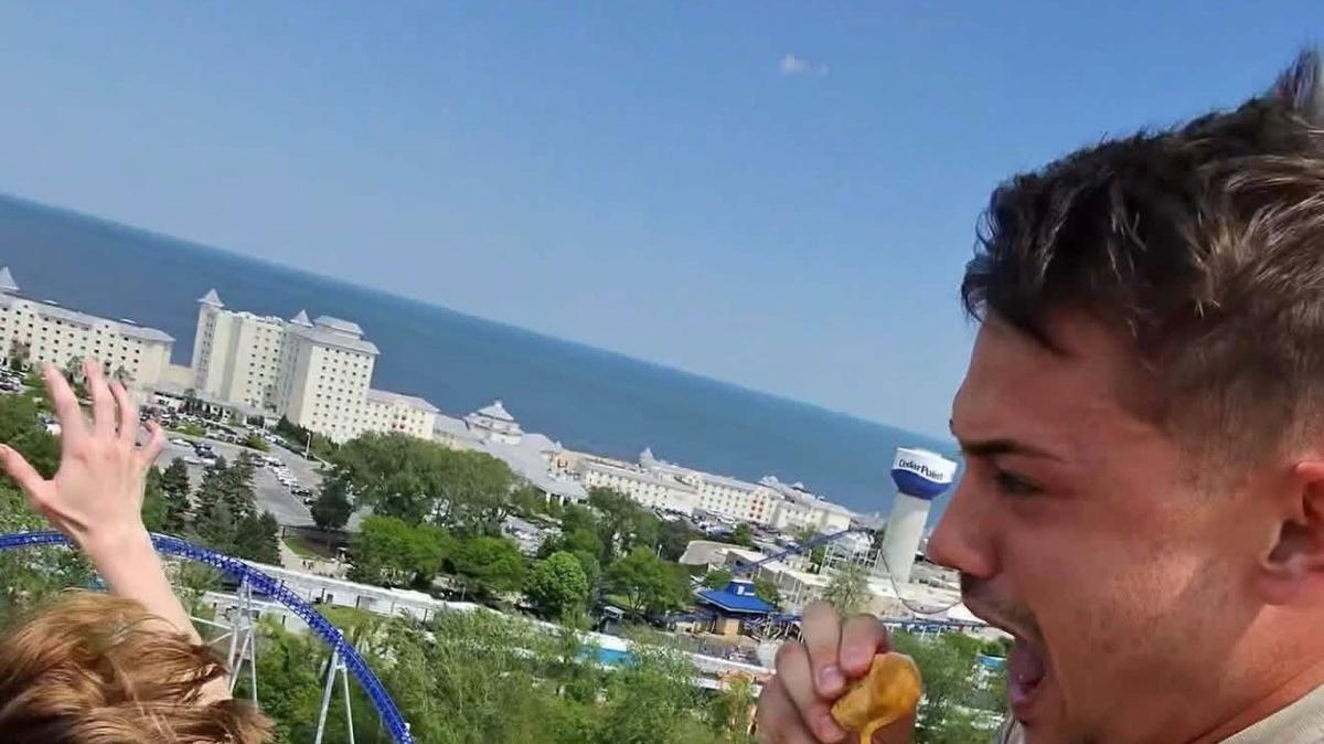 Allen Ferrell, 26, eats McDonald's Chicken McNuggets while riding a roller coaster on May 19, 2026 at Cedar Point theme park in Ohio.