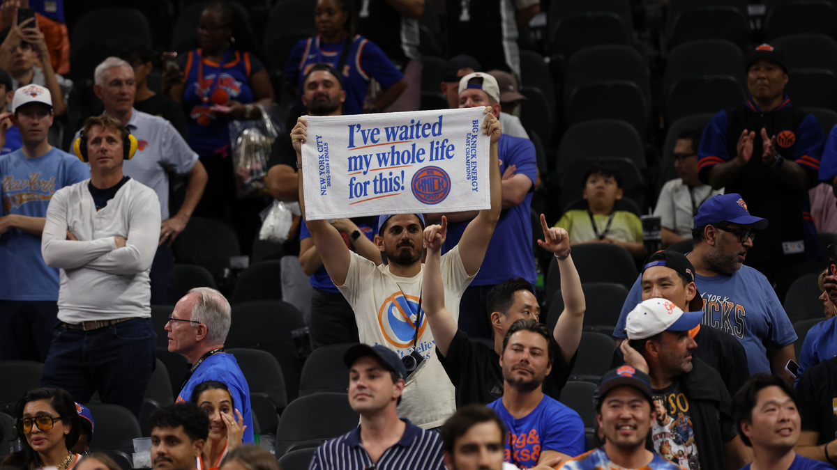 Jun 13, 2026; San Antonio, Texas, USA; A New York Knicks fan holds a towel in the stands during the championship trophy ceremony after game five of the 2026 NBA Finals against the San Antonio Spurs at Frost Bank Center. Mandatory Credit: Geoff Burke-Imagn Images
