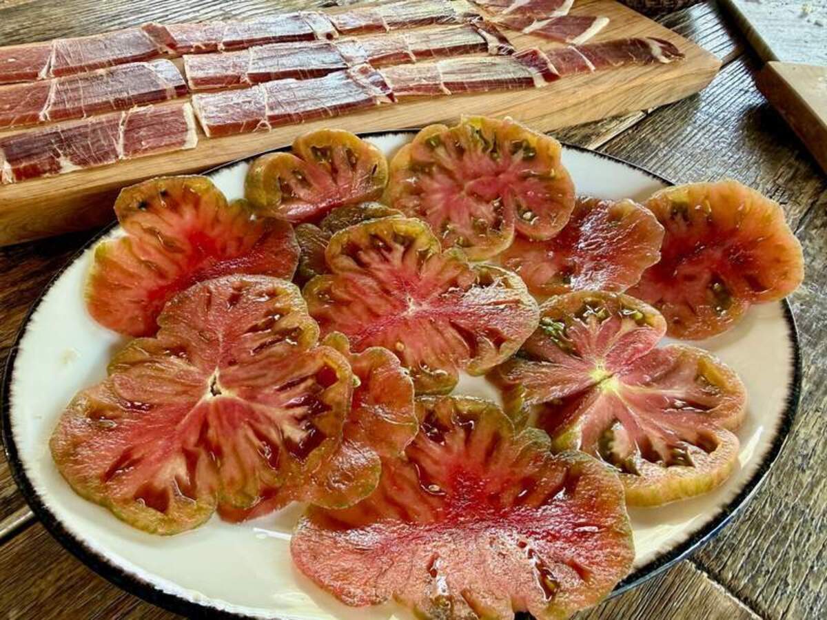  Sliced tomatoes and cured meats for lunch at Sacra Activa. Photo credit: Margot Black 