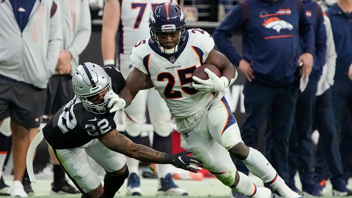 Denver Broncos running back Melvin Gordon (25) runs against Las Vegas Raiders defensive back Keisean Nixon (22) during the first half of an NFL football game, Sunday, Dec. 26, 2021, in Las Vegas. (AP Photo/Rick Scuteri)