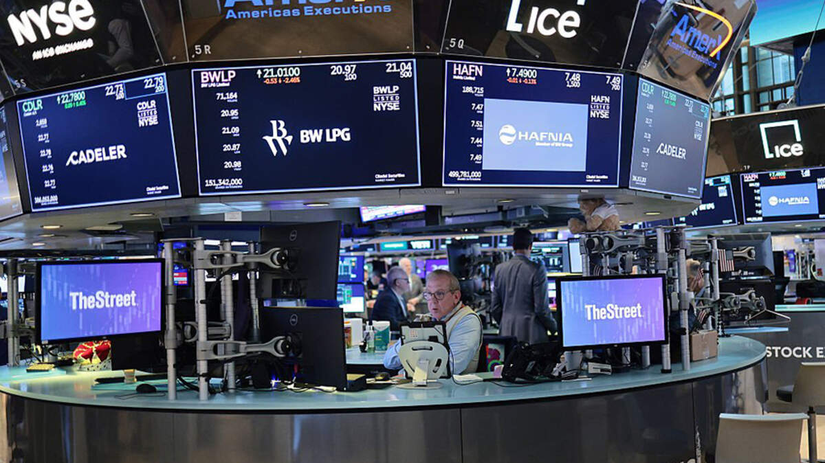 Traders work on the floor of the New York Stock Exchange during morning trading on Monday in New York City. Wall Street rallied on Monday, with the Nasdaq climbing 3% and the Dow marking a record-high close after the United States and Iran struck a preliminary agreement to end the Middle East war and reopen the Strait of Hormuz.