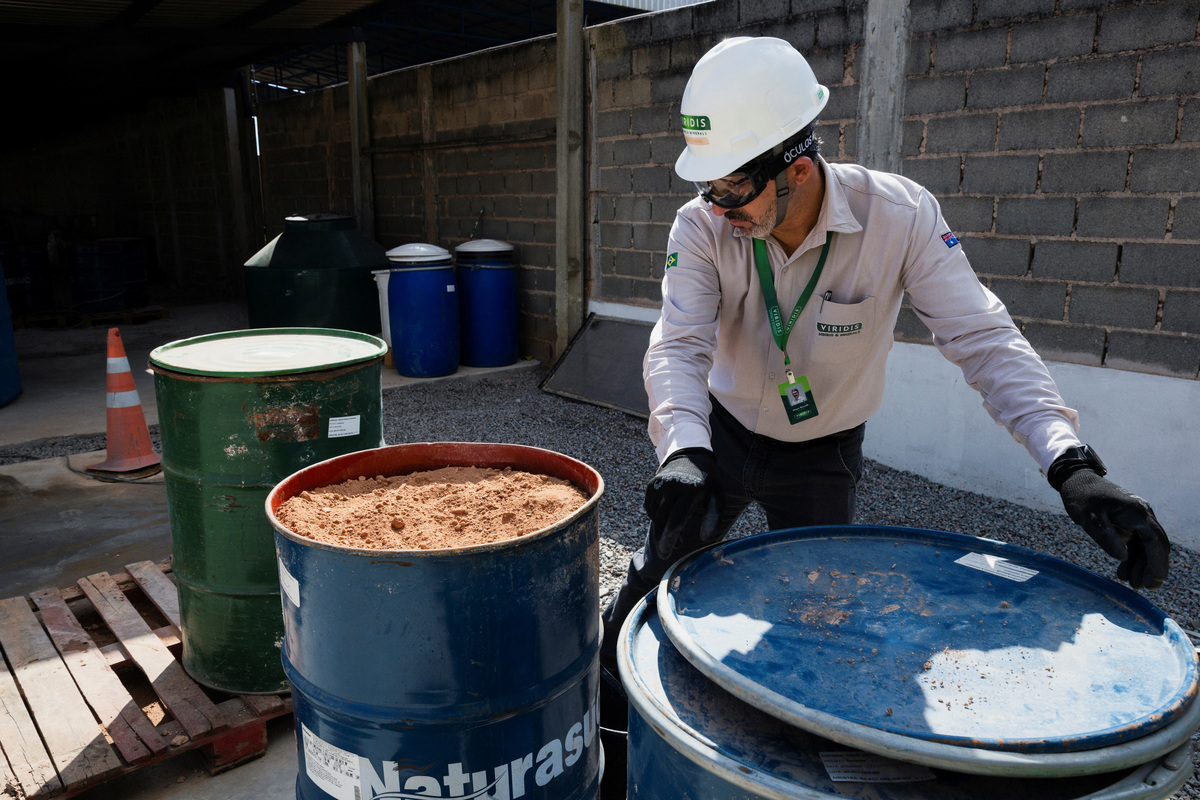 Moacir Rezende handles a container of rare earth samples at the rare earth research and processing center of Australian mining company Viridis Mining and Minerals during a visit of the EU Commissioner for International Partnerships Jozef Sikela, as the European Union is turning to Brazil as a strategic partner in its push to diversify critical mineral supplies, in Pocos de Caldas, Brazil, June 20, 2026. REUTERS/Tuane Fernandes