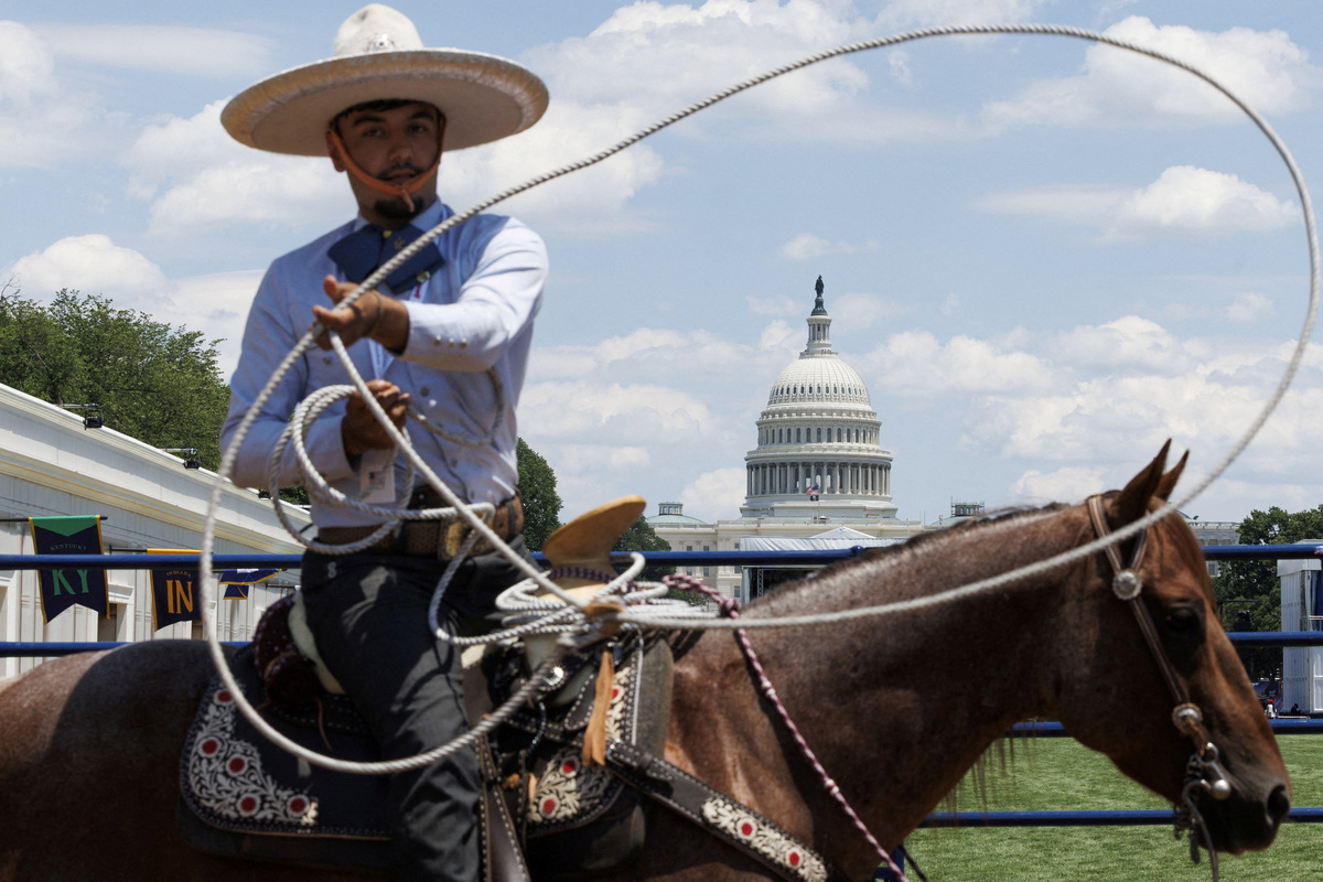 Gabriel Hernandez lassos a rope during a rodeo exhibition inside the Montana state exhibit at the Great American State Fair on the National Mall in Washington, D.C., U.S., June 25, 2026. REUTERS/Tom Brenner