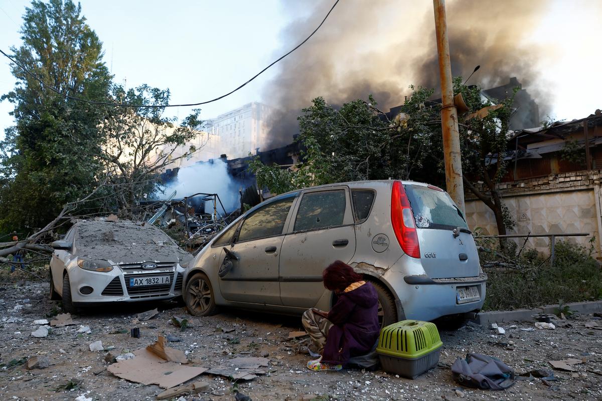 A child sits at the site of Russian missile and drone strikes, amid Russia's attack on Ukraine, in Kyiv, Ukraine June 2, 2026. REUTERS/Valentyn Ogirenko