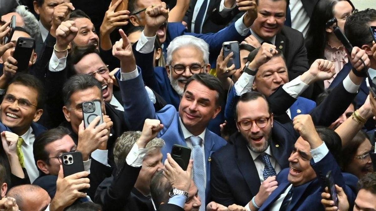 Sen. Flavio Bolsonaro (C), son of former Brazilian president Jair Bolsonaro, celebrates with members of Congress a vote that could reduce the sentences for coup attempts imposed on his father and others, in Brasilia, Brazil, on Thursday. Photo by Andre Borges/EPA
