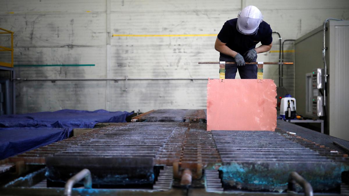 An employee holds a recycled copper plate at an urban mining plant in Gunsan, South Korea, April 2, 2018.   REUTERS/Kim Hong-Ji