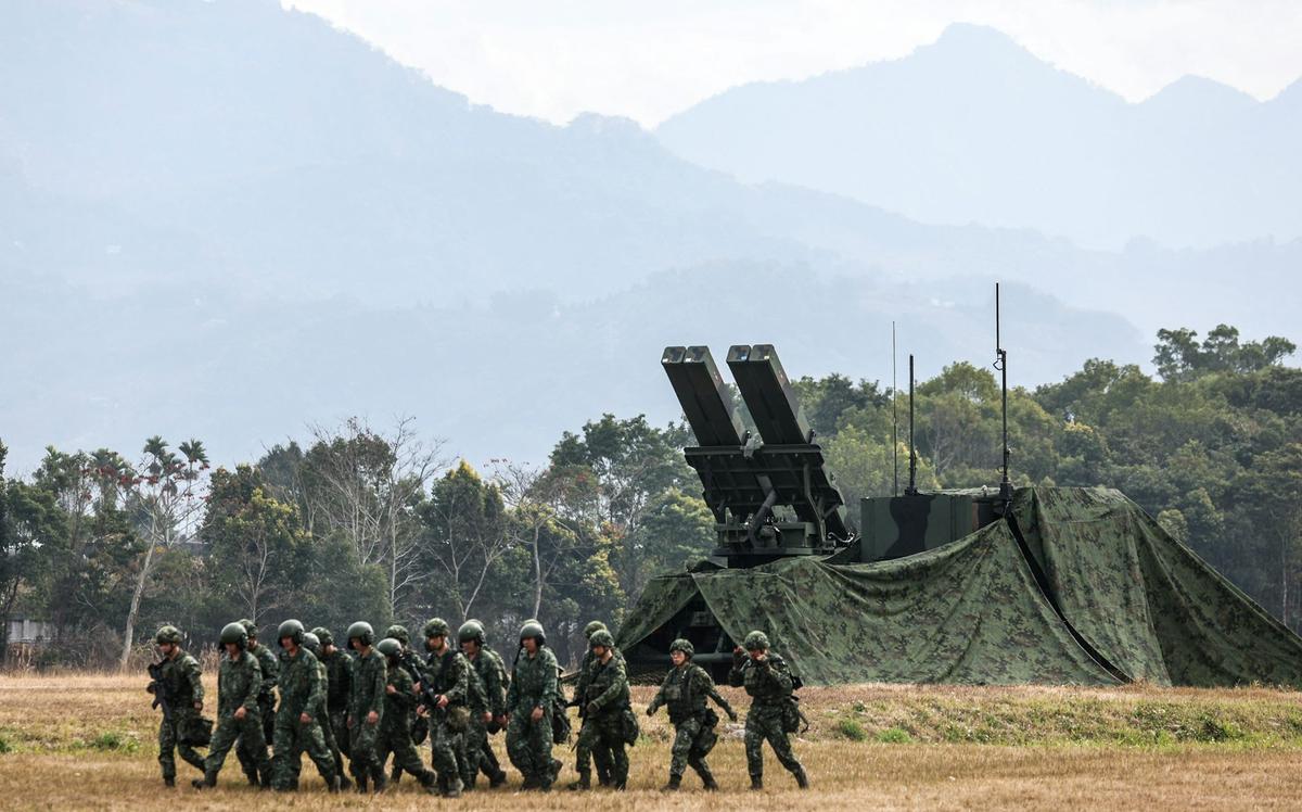  Taiwanese soldiers walk past a Sky Sword II Land-based Air Defense Missile in Taichung on Jan. 27, 2026. I-Hwa Cheng / AFP via Getty Images 