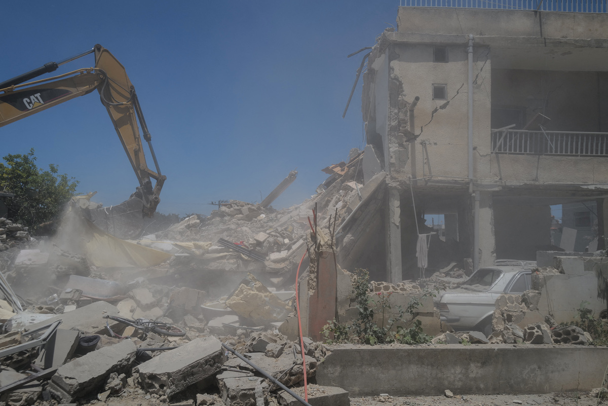 A machine works at the site of an Israeli air strike on a house as rescuers try to recover bodies from under the rubble, in Barish, in Tyre district, Lebanon June 20, 2026. REUTERS/Zohra Bensemra