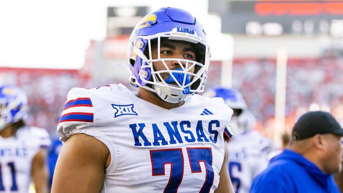  Nov 8, 2025; Tucson, Arizona, USA; Kansas Jayhawks offensive lineman Enrique Cruz Jr. (77) against the Arizona Wildcats at Arizona Stadium. Mandatory Credit: Mark J. Rebilas-Imagn Images | Mark J. Rebilas-Imagn Images 
