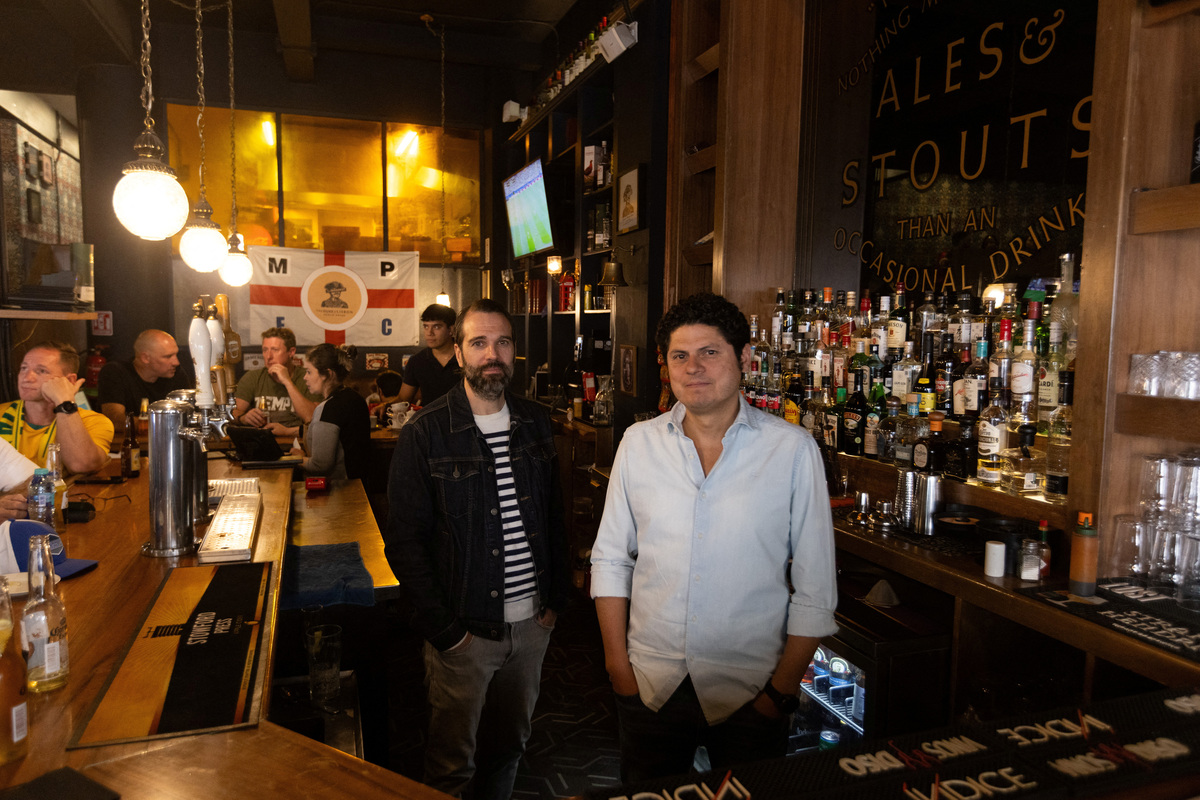 Luis Pena and Alex Mahoney, part of the management team, pose for a photo at the Duke of Lisbon pub, a British-Mexican bar, that expects to see fans gather to watch the FIFA World Cup 2026 match between Mexico and England in the World Cup Round of 16, in Mexico City, Mexico, July 3, 2026. REUTERS/Quetzalli Nicte-Ha