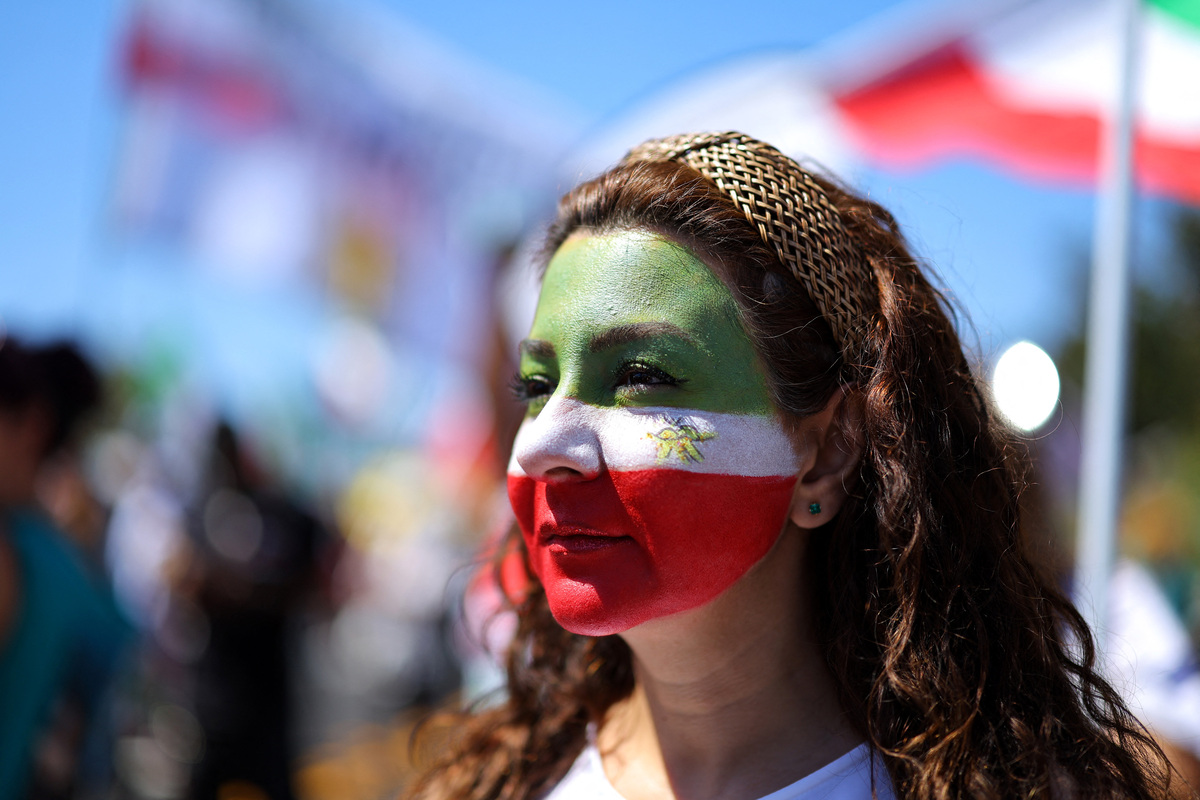 Soccer Football - FIFA World Cup 2026 - Group G - Iran v New Zealand - Los Angeles Stadium, Inglewood, California, U.S. - June 15, 2026 A protester has her face painted in Iran colors outside the stadium REUTERS/Mike Blake