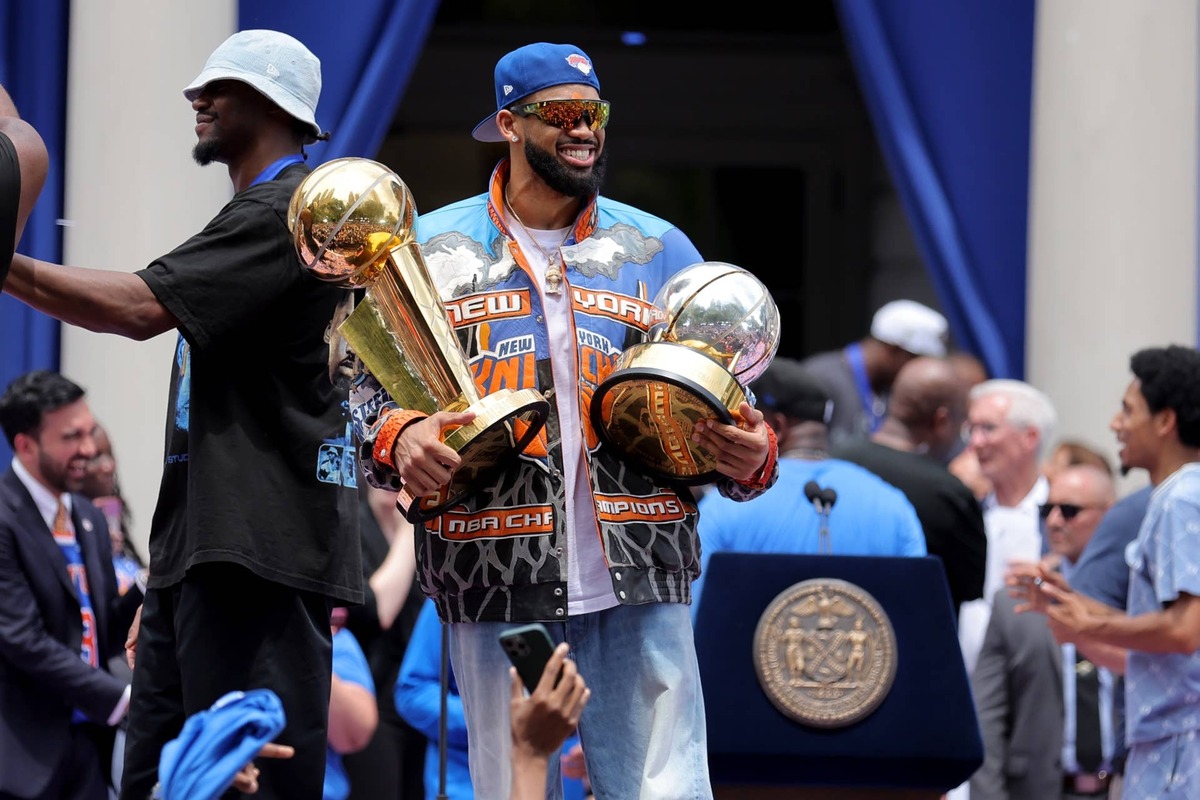  Jun 18, 2026; New York, NY, USA; New York Knicks center Karl-Anthony Towns celebrates with the Larry O'Brien championship trophy and the eastern conference finals trophy during a ceremony at New York City Hall after the championship parade. Mandatory Credit: Brad Penner-Imagn Images 