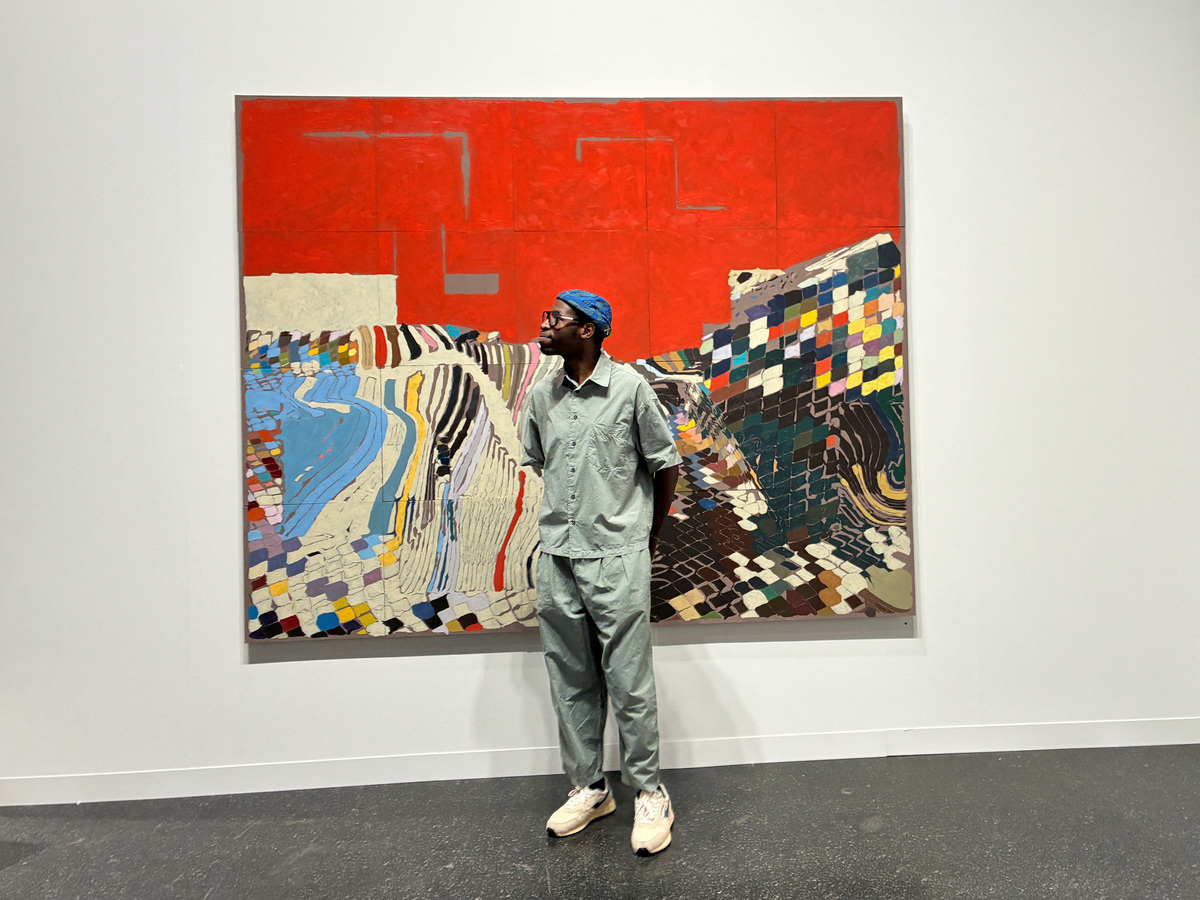 French artist William Mapan stands in front of his artwork at Art Basel, in Basel, Switzerland, June 17, 2026. Picture taken with a mobile phone. REUTERS/Marleen Kaesebier
