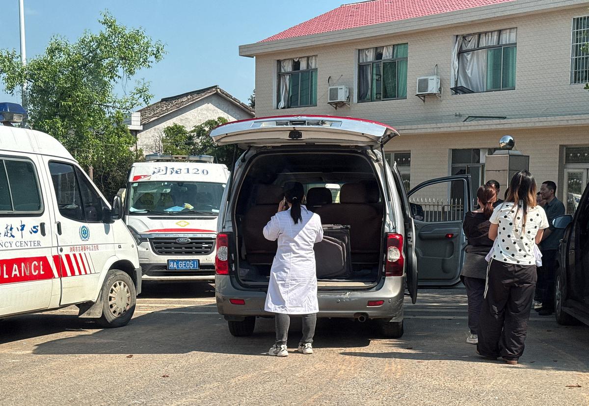 People gather next to ambulances after a blast at a fireworks manufacturing factory in Liuyang, Hunan province, China, May 6, 2026. REUTERS/Maxim Shemetov