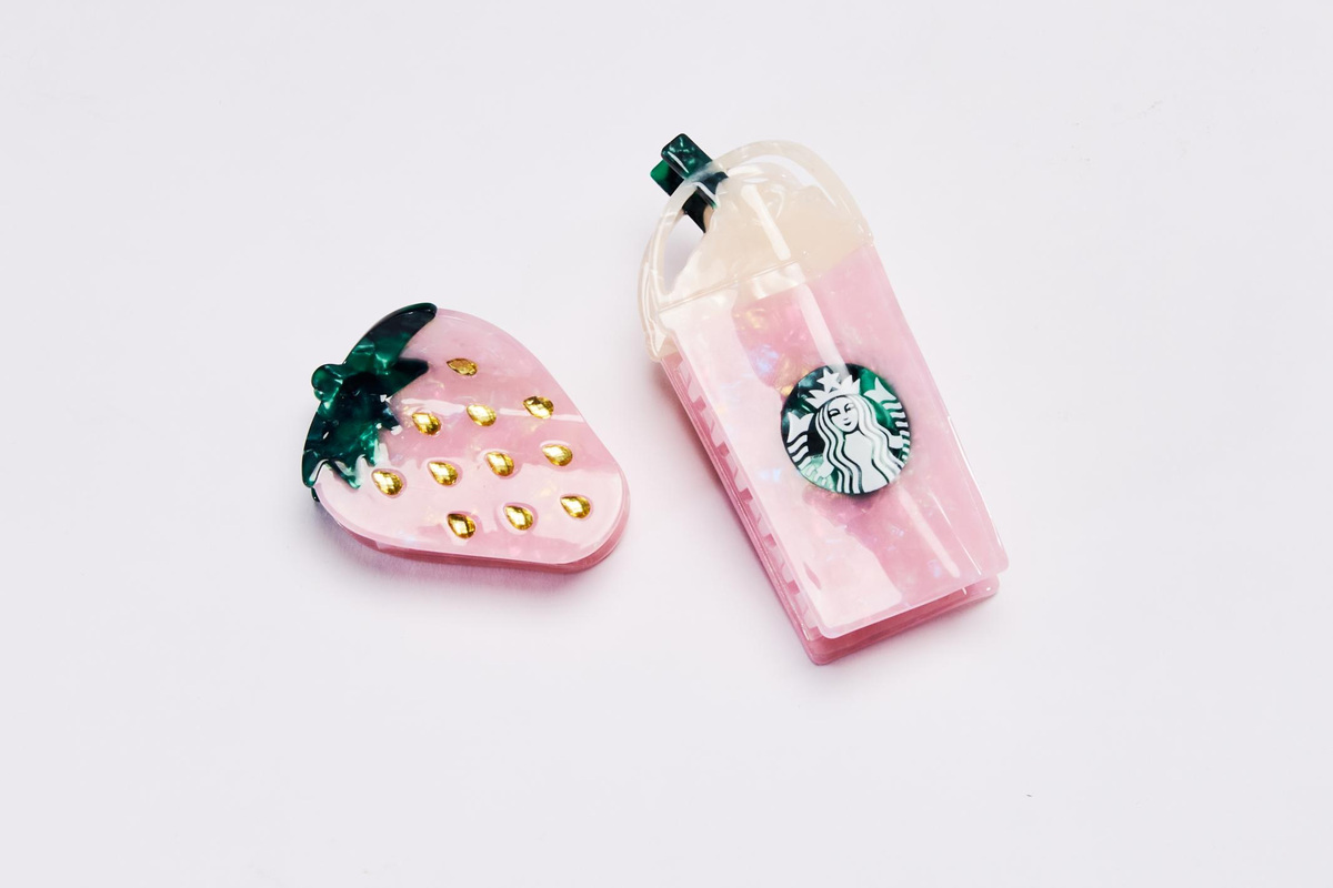 Starbucks unveiled a new line of merchandise inspired by its viral Pink Drink, available at select stores and online beginning July 7.