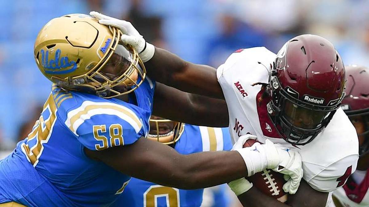  Sep 16, 2023; Pasadena, California, USA; North Carolina Central Eagles running back J'Mari Taylor (4) runs the ball against UCLA Bruins defensive lineman Gary Smith III (58) during the first half at Rose Bowl. Mandatory Credit: Gary A. Vasquez-Imagn Images | Gary A. Vasquez-Imagn Images 