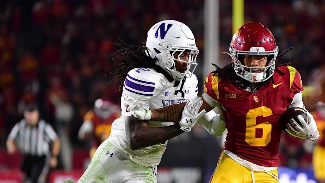  Nov 7, 2025; Los Angeles, California, USA; Southern California Trojans wide receiver Makai Lemon (6) runs the ball against Northwestern Wildcats cornerback Fred Davis II (2) during the second half at the Los Angeles Memorial Coliseum. Mandatory Credit: Gary A. Vasquez-Imagn Images | Gary A. Vasquez-Imagn Images 