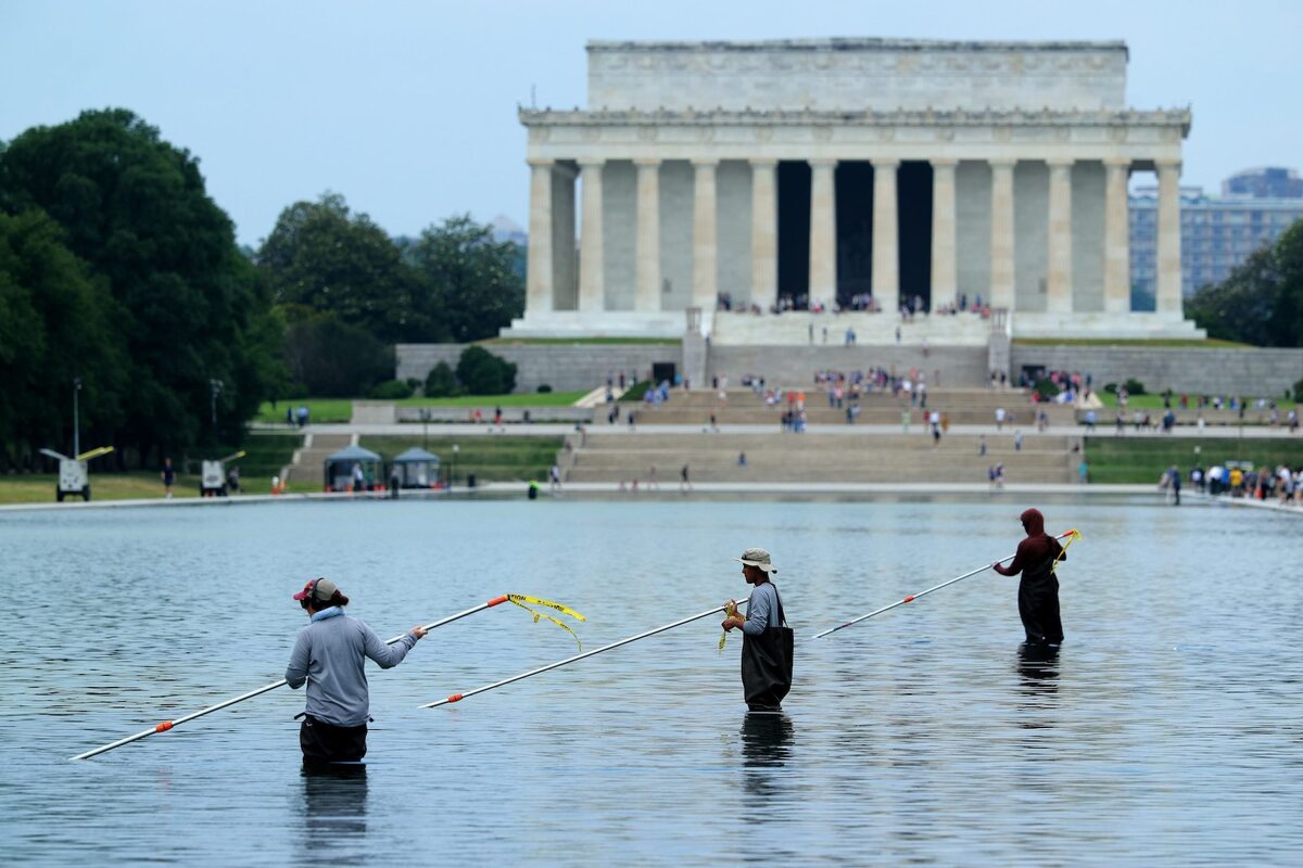  Park Service employees use vacuums to remove green algae from the bottom of the Lincoln Memorial Reflecting Pool.Chip Somodevilla/Getty Images 
