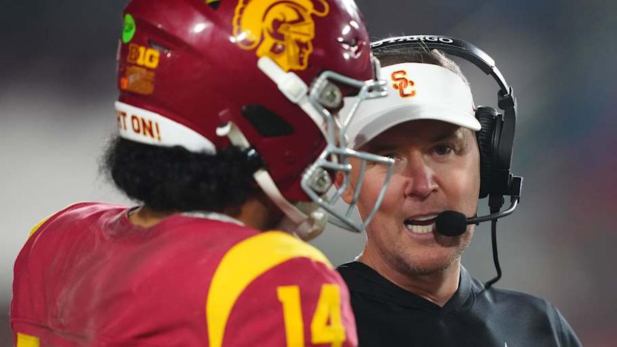  Nov 29, 2025; Los Angeles, California, USA; Southern California Trojans head coach Lincoln Riley (right) talks with quarterback Jayden Maiava (14) in the second half against the UCLA Bruins at United Airlines Field at Los Angeles Memorial Coliseum. Mandatory Credit: Kirby Lee-Imagn Images | Kirby Lee-Imagn Images 