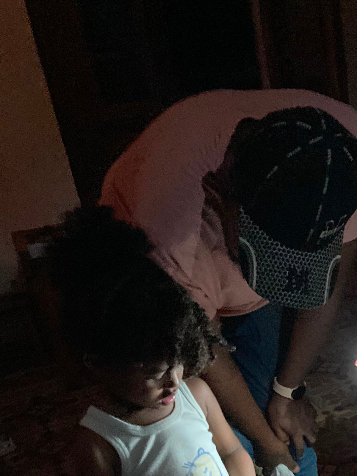 Jorge Luis del Valle, center, his wife, Danneys, and their 4-year-old daughter Emma sort through supplies during an extended blackout in their Old Havana apartment. Del Valle and his family typically endure 20-hour daily blackouts.