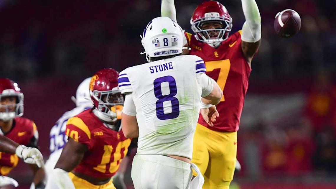  Nov 7, 2025; Los Angeles, California, USA; Northwestern Wildcats quarterback Preston Stone (8) throws under pressure from Southern California Trojans safety Kamari Ramsey (7) during the second half at the Los Angeles Memorial Coliseum. Mandatory Credit: Gary A. Vasquez-Imagn Images | Gary A. Vasquez-Imagn Images 