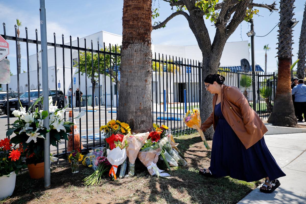 A woman pays her respects, outside the Islamic Centre of San Diego, the morning following a shooting, in San Diego, California, U.S, May 19, 2026.  REUTERS/ Mike Blake