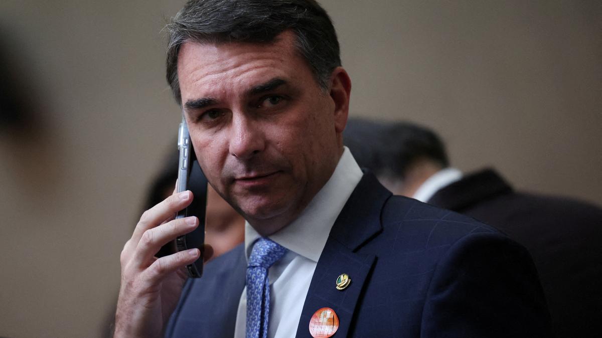 FILE PHOTO: Senator Flavio Bolsonaro uses his phone in Brasilia, Brazil, May 12, 2026.REUTERS/Adriano Machado/File Photo