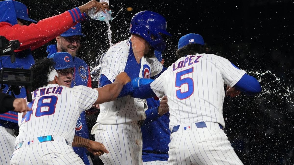 Cubs first baseman Michael Busch celebrates his walk-off single during the 10th inning of Tuesday’s 3-2 win against the Reds.