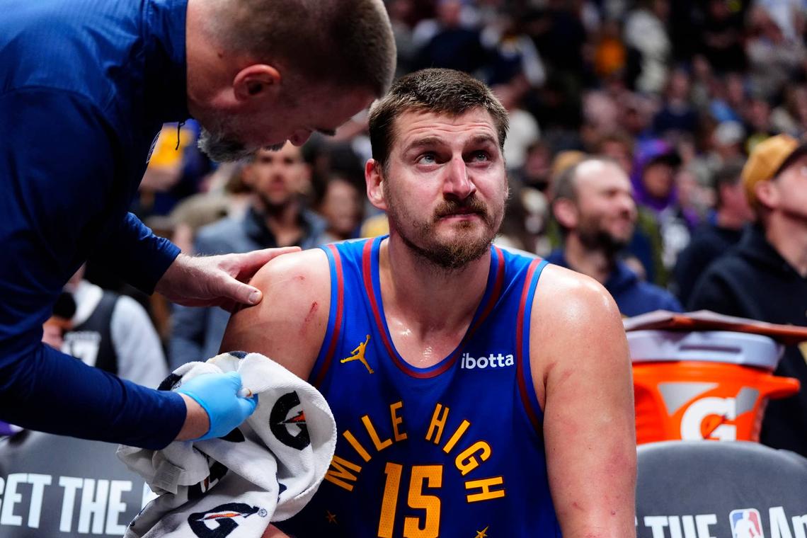  Denver Nuggets center Nikola Jokić is treated on the bench during his team's game against the Houston Rockets at Ball Arena on March 11, 2026. Ron Chenoy-Imagn Images