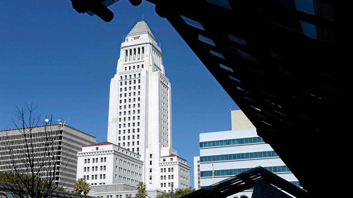 Los Angeles City Hall is framed by the facade in front of the Caltrans building on a bright sunshiny Southern California Day in Los Angeles.  (Photos by John McCoy / Los Angeles Daily News)