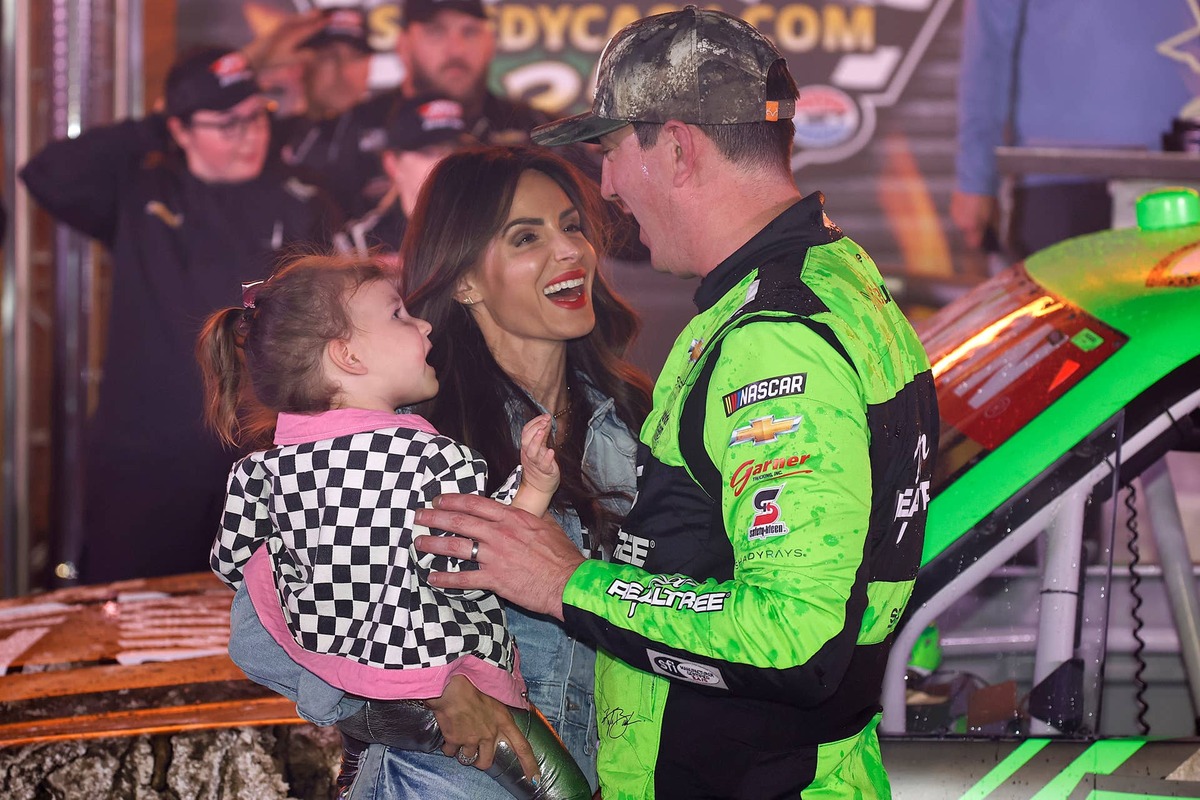  FORT WORTH, TEXAS - APRIL 12: Kyle Busch, driver of the #7 Realtree Chevrolet, celebrates with his wife, Samantha Busch, and daughter, Lennix Busch victory lane after winning the NASCAR Craftsman Truck Series SpeedyCash.com 250 at Texas Motor Speedway on April 12, 2024 in Fort Worth, Texas. (Photo by Chris Graythen/Getty Images) 