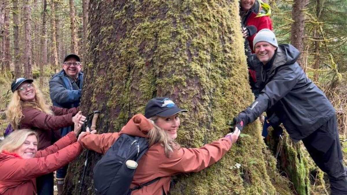  Group hugging a Spruce tree on the Lake Eva Trail in the Tongass National Forest. Photo credit: The Boat Company 