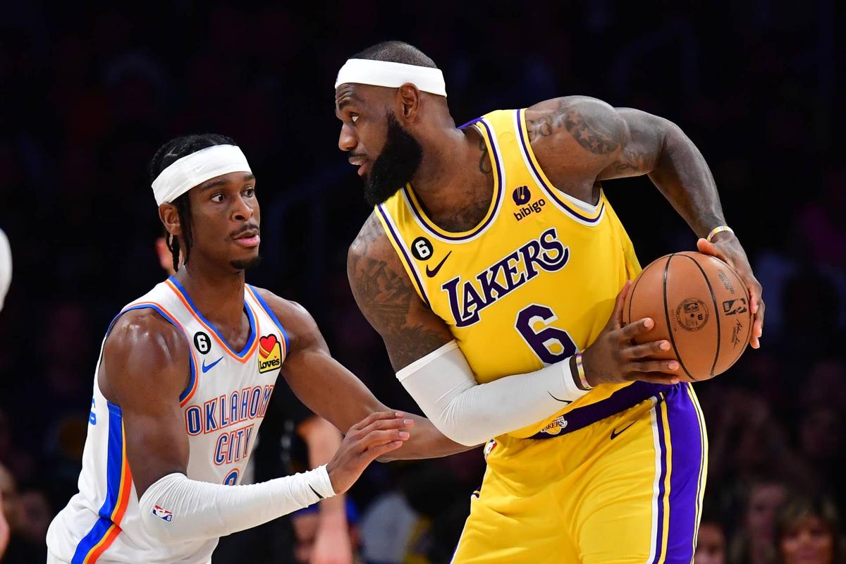  Oklahoma City Thunder guard Shai Gilgeous-Alexander (2) defends against Los Angeles Lakers forward LeBron James (6) at Crypto.com Arena. Gary A. Vasquez-Imagn Images