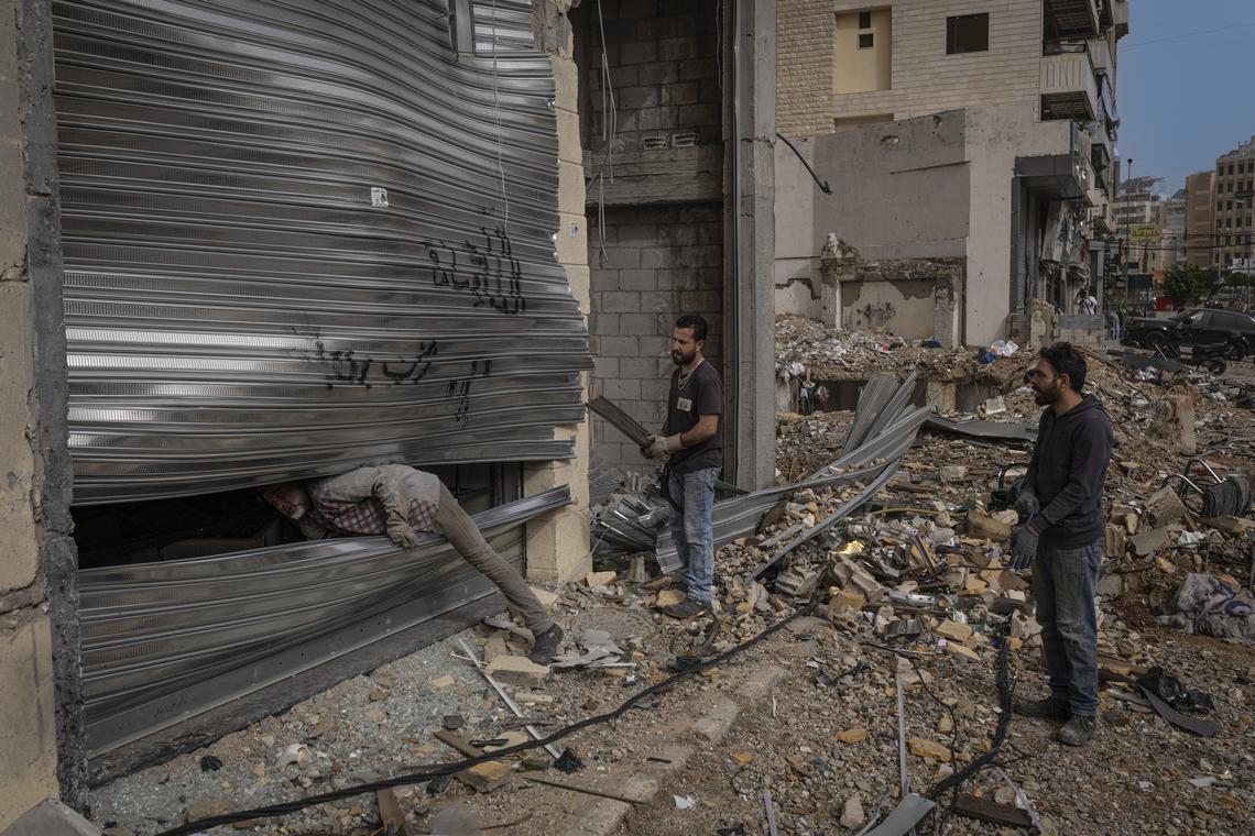 Lebanese men assess damage from Israeli airstrikes in the streets of Dahiyeh, the large southern suburb of Beirut, on the second day of a ceasefire, Saturday, April 18, 2026. People continued to travel back to southern Lebanon in large numbers on Saturday, enabling residents to take stock of the scale of destruction of their homes and villages. (Diego Ibarra Sánchez/The New York Times)