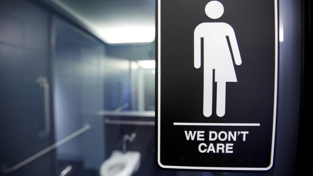 A sign protesting a recent North Carolina law restricting transgender bathroom access adorns the bathroom stalls at a hotel in Durham, North Carolina May 3, 2016. REUTERS/Jonathan Drake/File Photo