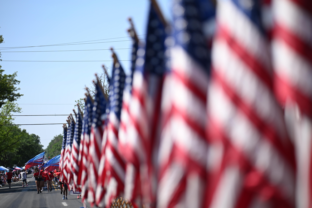 A line of flags, during the Greeley Stampede's Independence Day parade in Greeley, Colo., July 4, 2026. America celebrates the 250th anniversary of its independence today, with people from one end of the country to the other marking the milestone with fireworks, parades and concerts. (Mark Makela/The New York Times)