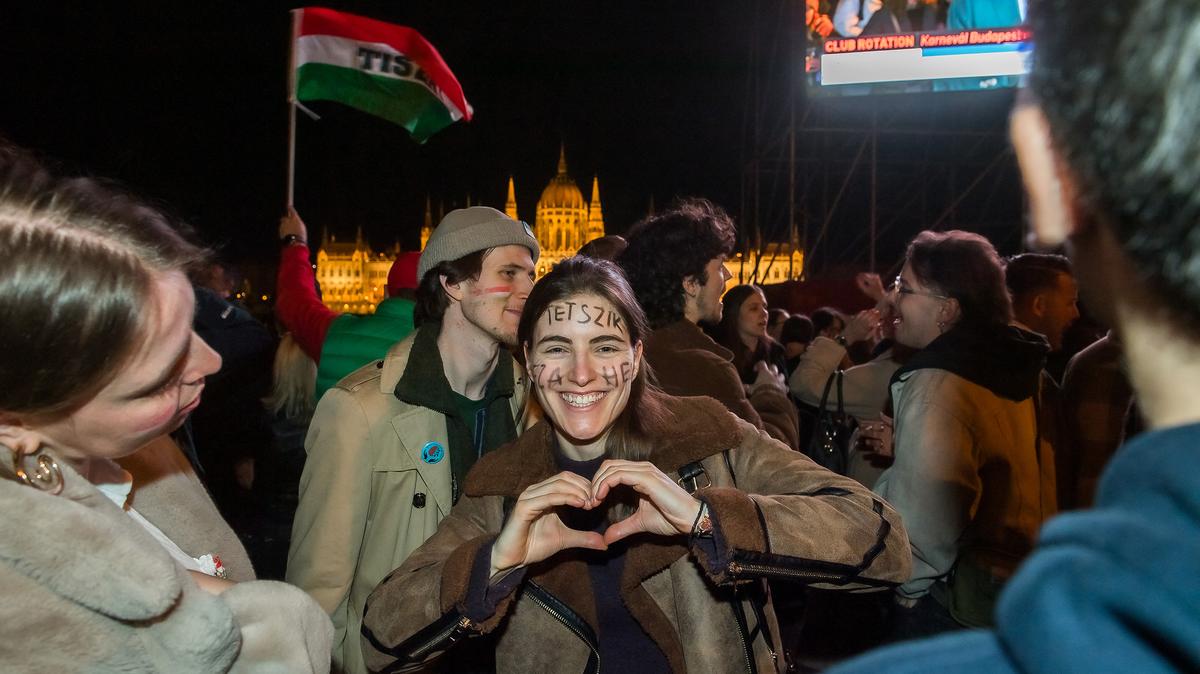 People celebrate in the streets after Peter Magyar, leader of the pro-European conservative TISZA party, addressed supporters at their election night party in Budapest during the general election in Hungary, on Sunday, April 12, 2026. (Ferenc Isza/AFP/Getty Images/TNS)