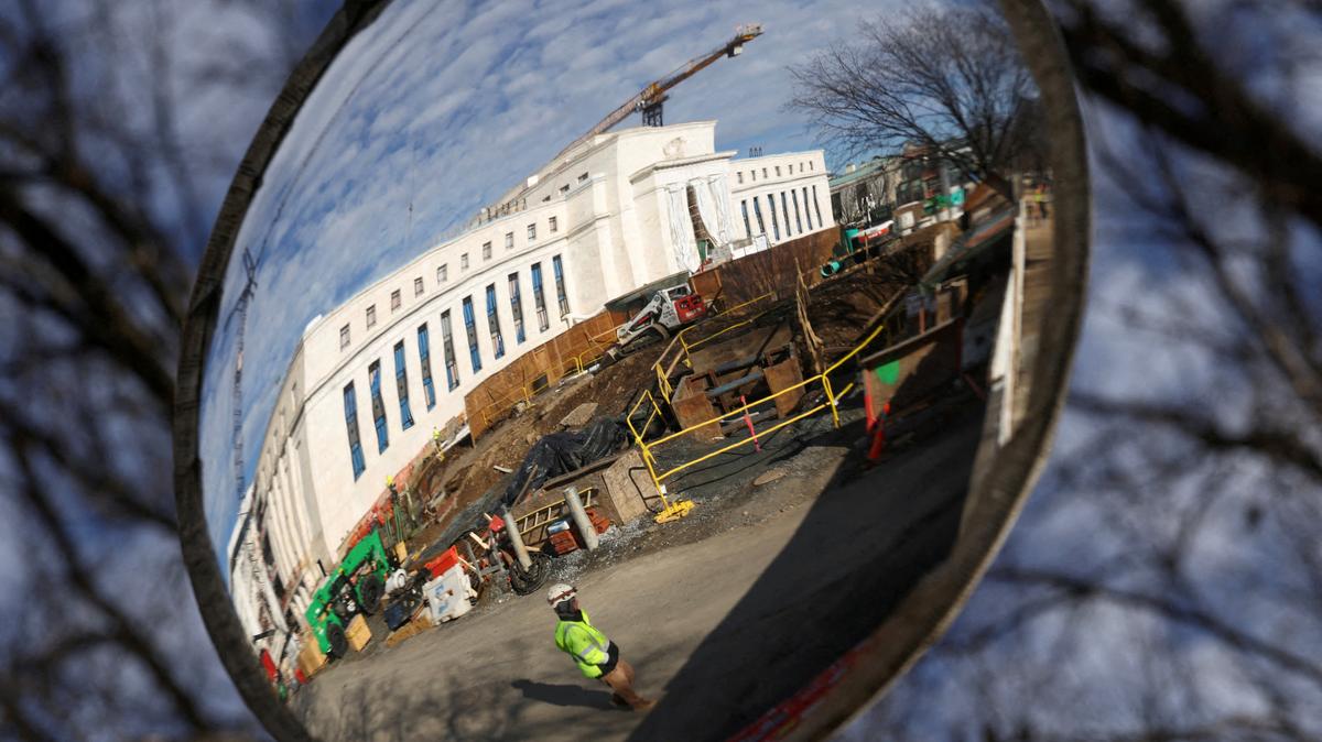 FILE PHOTO: A mirror reflects the construction site of the Federal Reserve headquarters in Washington, D.C., U.S., January 12, 2026. REUTERS/Kevin Lamarque/File Photo
