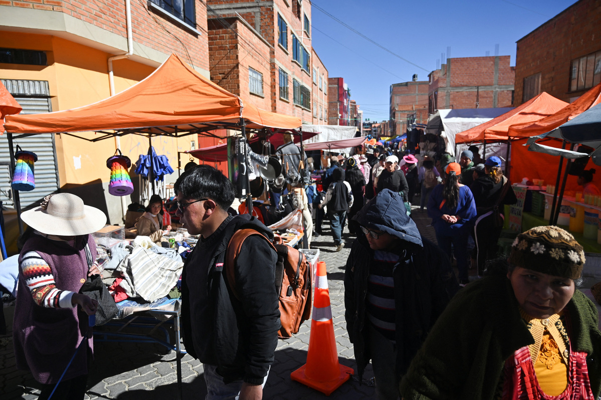 People visit a market to stock up on food and other supplies as Bolivia's crisis begins to ease after lawmakers backed the state of emergency, in El Alto, Bolivia, June 21, 2026. REUTERS/Claudia Morales