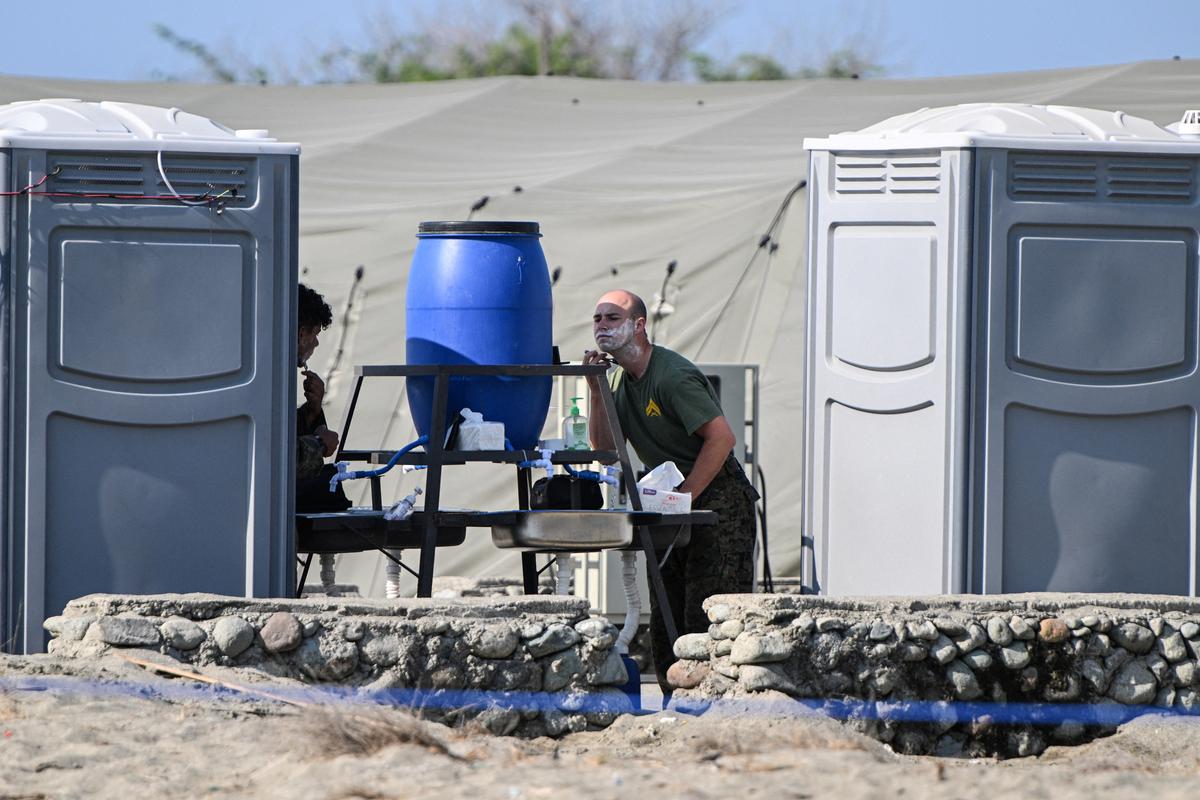 U.S. soldiers shave their beards before the start of the Joint Task Force (JTF) Maritime Strike, part of Balikatan, the annual joint military exercises between the United States and the Philippines, at Culili Point Sand Dunes, Paoay, Ilocos Norte province, Philippines, May 6, 2026. REUTERS/Noel Celis