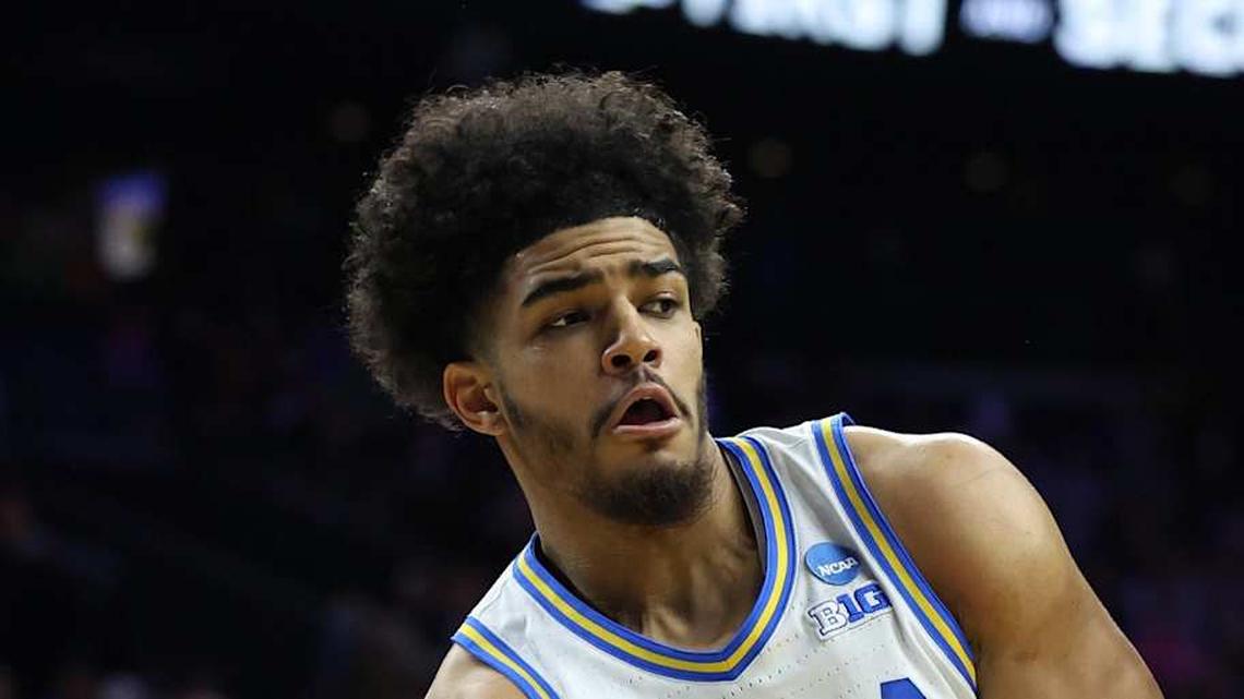 Mar 20, 2026; Philadelphia, PA, USA; UCLA Bruins guard Eric Freeny (8) makes a pass against UCF Knights center John Bol (7) in the second half during a first round game of the men's 2026 NCAA Tournament at Xfinity Mobile Arena. Mandatory Credit: Bill Streicher-Imagn Images | Bill Streicher-Imagn Images 