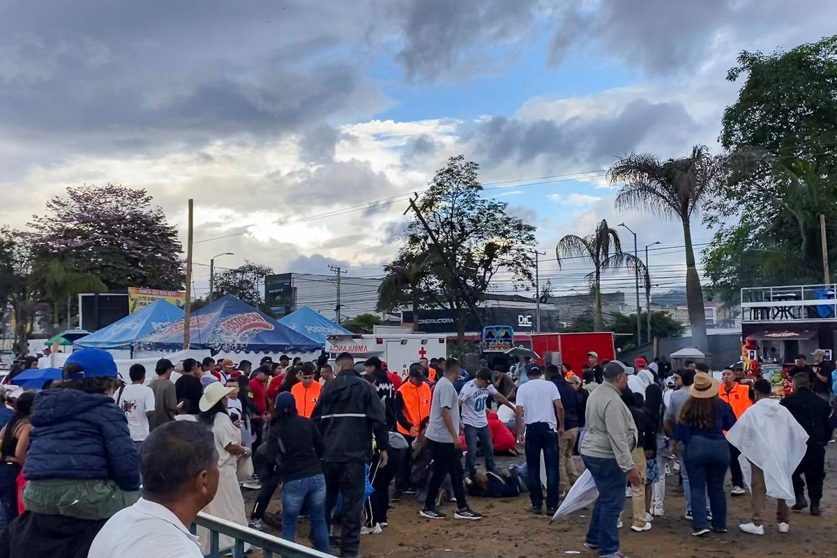 People stand near the injured after a monster truck driver lost control of the vehicle during a show and plowed into spectators, killing people and injuring others, in Popayan, Cauca province, Colombia, May 3, 2026. Picture taken with a mobile phone. REUTERS/Henry Laserna