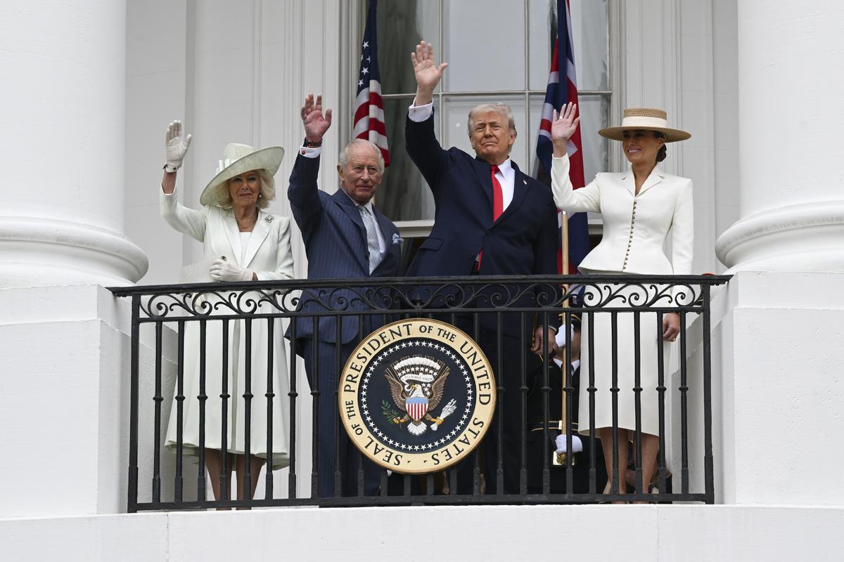 From right: first lady Melania Trump, President Donald Trump, King Charles III, and Queen Camilla watch a pass in review from a balcony of the White House during an arrival ceremony in Washington, on Tuesday, April 28, 2026. (Kenny Holston/The New York Times)