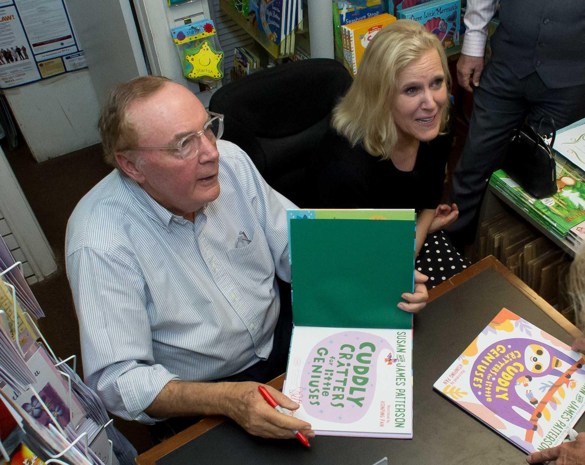 Palm Beach resident and best-selling author James Patterson signs a copy of one of his books for a fan in 2018 inside Classic Bookshop. He is seated next to his wife, Susan.