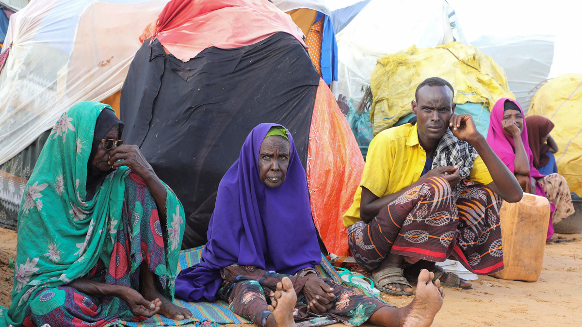 Internally displaced people sit outside their makeshift shelters in Kahda district of Mogadishu, Somalia May 7, 2026. REUTERS/Feisal Omar
